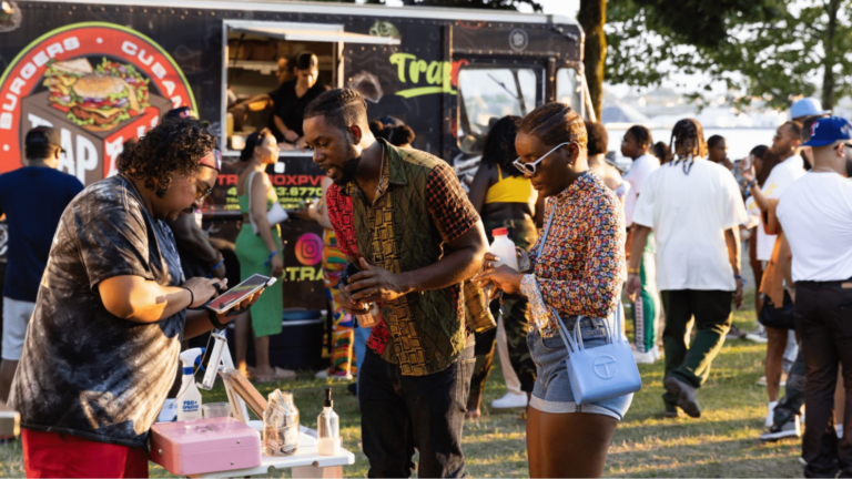People at a stand at a food truck festival