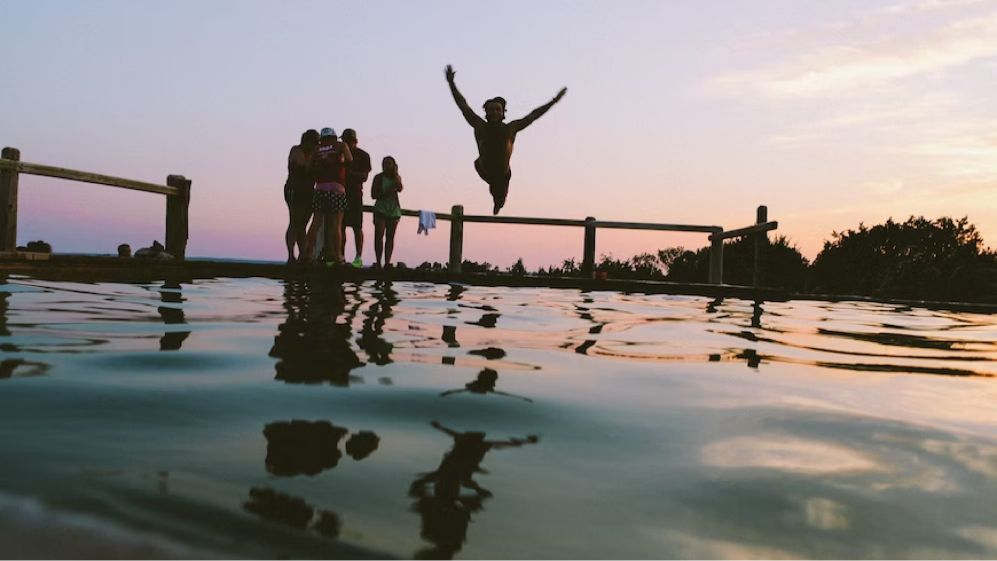 Man drives into lake while people look on