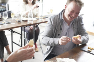 Attendee enjoys a cheese education class at Murray's Cheese in NYC.