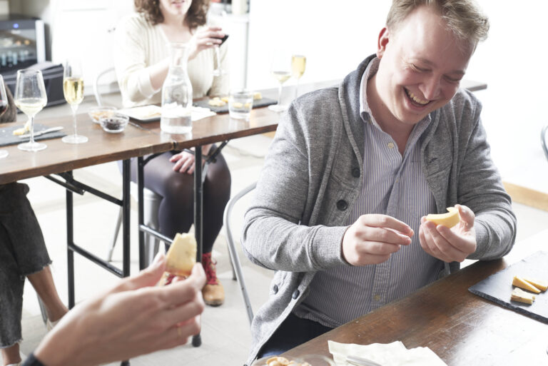Attendee enjoys a cheese education class at Murray's Cheese in NYC.
